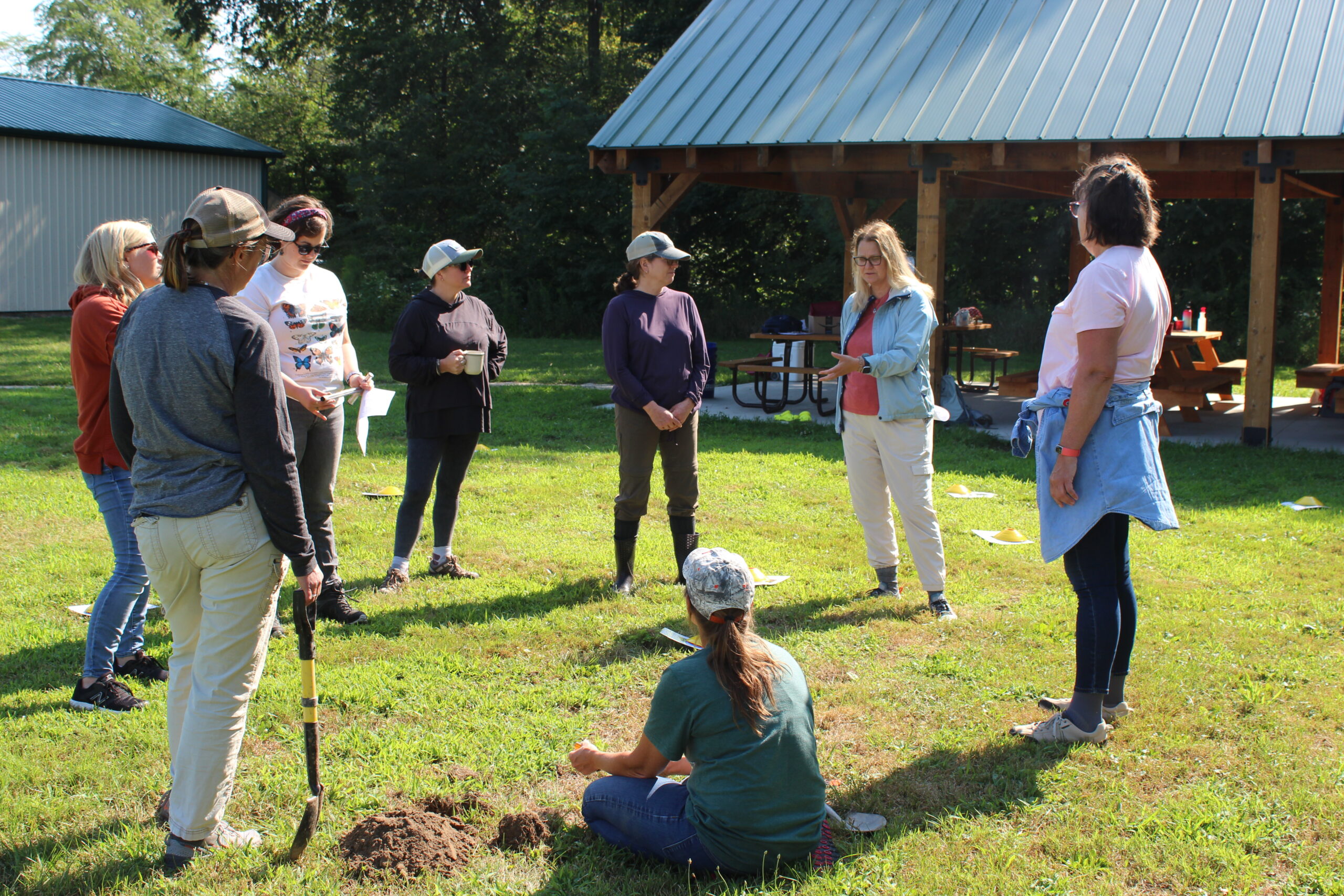 Educators gathered in a circle discussing an educational program